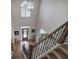 View from a staircase with hardwood steps, iron spindles and a view to the front door at 2139 Golden Morning Ct, Kennesaw, GA 30152