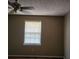 Neutral painted bedroom featuring a window with blinds and ceiling fan light at 46 Mac Johnson Nw Rd, Cartersville, GA 30121