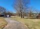 Long driveway leading to a house and parking spaces, bordered by grassy lawns and mature trees at 46 Mac Johnson Nw Rd, Cartersville, GA 30121