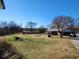 Expansive front yard featuring a pool and a well-maintained lawn surrounding a single-story home and driveway at 46 Mac Johnson Nw Rd, Cartersville, GA 30121