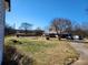 Expansive front yard featuring a pool and a well-maintained lawn surrounding a single-story home and driveway at 46 Mac Johnson Nw Rd, Cartersville, GA 30121