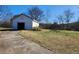Exterior shot of outbuilding with driveway leading to a large front door entrance at 46 Mac Johnson Nw Rd, Cartersville, GA 30121