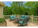 Relaxing back deck with comfortable seating and a view of the lush, green backyard at 730 Jackson Miller Cir, Powder Springs, GA 30127