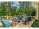 Outdoor back deck featuring a grill, comfortable seating, and a view of the lush greenery at 730 Jackson Miller Cir, Powder Springs, GA 30127
