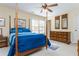 Comfortable bedroom featuring a four-poster bed, ceiling fan, dresser, and natural light from the window at 730 Jackson Miller Cir, Powder Springs, GA 30127