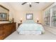 Cozy bedroom with a patterned bedspread, wooden furniture, and natural light from the windows at 730 Jackson Miller Cir, Powder Springs, GA 30127