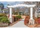 View of the community gazebo and landscaping seen through a white pergola at 730 Jackson Miller Cir, Powder Springs, GA 30127