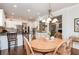 Inviting dining area with warm wood table, a decorative chandelier, and an open view to the kitchen at 730 Jackson Miller Cir, Powder Springs, GA 30127