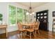 Bright dining area with hardwood floors, large windows, and a stylish chandelier at 730 Jackson Miller Cir, Powder Springs, GA 30127