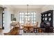 Charming dining area with hardwood floors, a decorative hutch, and natural light from large windows at 730 Jackson Miller Cir, Powder Springs, GA 30127