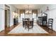 Formal dining room with a chandelier, dark wood furniture, and patterned rug at 730 Jackson Miller Cir, Powder Springs, GA 30127
