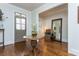 Welcoming foyer featuring hardwood floors, a decorative table with floral arrangement, and stylish accents at 730 Jackson Miller Cir, Powder Springs, GA 30127
