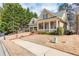 Charming home with a well-manicured lawn, mature trees, and a welcoming front porch at 730 Jackson Miller Cir, Powder Springs, GA 30127