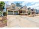 Craftsman home featuring a large driveway, a two car garage, and a welcoming front porch at 730 Jackson Miller Cir, Powder Springs, GA 30127