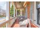 Inviting front porch with brick flooring, comfortable wicker chairs, and traditional white railing and columns at 730 Jackson Miller Cir, Powder Springs, GA 30127
