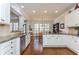 Spacious kitchen featuring white cabinets, granite countertops, stainless appliances, and hardwood floors at 730 Jackson Miller Cir, Powder Springs, GA 30127