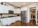 Stylish kitchen featuring stainless steel appliances, granite counters, and white cabinets at 730 Jackson Miller Cir, Powder Springs, GA 30127