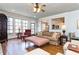 Open living room with large windows, hardwood floors, and cozy seating at 730 Jackson Miller Cir, Powder Springs, GA 30127