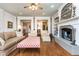 Elegant living room featuring a fireplace, hardwood floors, and stylish furnishings at 730 Jackson Miller Cir, Powder Springs, GA 30127
