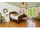 Elegant main bedroom with hardwood floors, large bed, and natural light from a large window at 730 Jackson Miller Cir, Powder Springs, GA 30127
