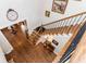 Elevated view of a wood staircase with iron railings, complemented by hardwood floors and wall decor at 730 Jackson Miller Cir, Powder Springs, GA 30127