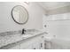 Updated bathroom with granite countertops, modern fixtures, and a shower-tub combo at 2450 Spring Mill Cv, Duluth, GA 30097