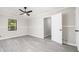 Bright bedroom featuring wood-look floors, neutral walls, and a ceiling fan at 2450 Spring Mill Cv, Duluth, GA 30097