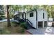 Charming home with a black and white exterior, landscaped yard and convenient two-car garage at 2450 Spring Mill Cv, Duluth, GA 30097