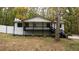 Charming home featuring a covered front porch, white siding and black trim at 2450 Spring Mill Cv, Duluth, GA 30097