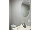Bathroom boasts a white countertop sink and a modern, round, frameless mirror at 2678 Brook Park Way, Atlanta, GA 30340