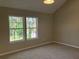 Bedroom with a sunny window and neutral-colored walls and plush carpeting at 2678 Brook Park Way, Atlanta, GA 30340