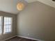 Bedroom with neutral walls, wood-look floors, and a vaulted ceiling with a modern light fixture at 2678 Brook Park Way, Atlanta, GA 30340