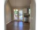 Dining room with wood-look floors leading to a deck through glass doors, next to a modern kitchen at 2678 Brook Park Way, Atlanta, GA 30340