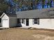 A well-maintained single-story home showcasing neutral siding, and a cozy front entrance at 2678 Brook Park Way, Atlanta, GA 30340
