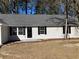A charming single-story home with neutral siding and classic black shutters on the windows at 2678 Brook Park Way, Atlanta, GA 30340