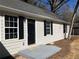 Close-up of the front entrance featuring a black door and matching shutters on a charming home at 2678 Brook Park Way, Atlanta, GA 30340