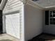 Attached single-car garage featuring a white door and neutral siding at 2678 Brook Park Way, Atlanta, GA 30340