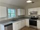 Modern kitchen with white cabinets, granite countertops, and stainless steel appliances at 2678 Brook Park Way, Atlanta, GA 30340