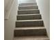 Carpeted stairs with white handrail offer a safe and stylish transition at 2678 Brook Park Way, Atlanta, GA 30340