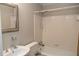 Clean bathroom with a white tiled shower, toilet and a framed mirror above the sink at 115 Biscayne Dr # C2, Atlanta, GA 30309