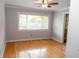 Bedroom with hardwood floors, ceiling fan, and a large window for natural light at 115 Biscayne Dr # C2, Atlanta, GA 30309