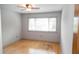 Bright bedroom featuring hardwood floors, large window for natural light, and a ceiling fan at 115 Biscayne Dr # C2, Atlanta, GA 30309