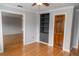 Bright bedroom featuring hardwood floors, a ceiling fan and a built-in bookshelf at 115 Biscayne Dr # C2, Atlanta, GA 30309
