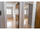 Hallway featuring hardwood floors leading to other rooms with natural light at 115 Biscayne Dr # C2, Atlanta, GA 30309