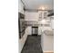 Modern kitchen with granite countertops, stainless steel appliances, and black slate flooring at 115 Biscayne Dr # C2, Atlanta, GA 30309