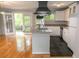 Open-concept living room with a modern kitchen featuring stainless steel appliances and granite countertops at 115 Biscayne Dr # C2, Atlanta, GA 30309