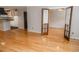 Living room featuring hardwood floors leading to a kitchen with white cabinetry at 115 Biscayne Dr # C2, Atlanta, GA 30309