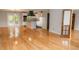 Bright open-concept living room with hardwood floors and an updated kitchen in the background at 115 Biscayne Dr # C2, Atlanta, GA 30309