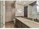 Modern bathroom featuring double sinks, a large mirror, and a glass-enclosed shower with marble tile at 805 Peachtree Ne St # 614, Atlanta, GA 30308