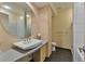 Bright bathroom featuring granite counters, round mirror, and neutral tiling at 805 Peachtree Ne St # 614, Atlanta, GA 30308